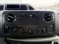 Dashboard of a 2019 Ford Econoline featuring a radio control panel and air conditioning vents with knobs for temperature and airflow adjustments