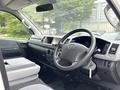 Interior of a 2009 Toyota Hiace featuring a steering wheel dashboard controls and seating area