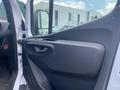 Interior door panel of a 2024 Mercedes-Benz Sprinter featuring a streamlined design with a handle and control buttons for windows and locks