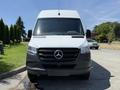 Front view of a 2019 Mercedes-Benz Sprinter with a white body and black grille featuring the Mercedes-Benz logo