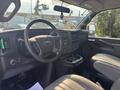 Interior view of a 2021 Chevrolet Express van showing the dashboard steering wheel and front seats