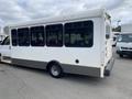A 2020 Chevrolet Express shuttle bus with a white exterior and large tinted windows parked at an angle