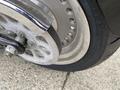 Close-up of a 2008 Harley-Davidson FLSTFI motorcycle wheel showing the chrome rim and tire tread details