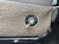 A battery switch mounted on a textured surface in a vehicle featuring an off and on indicator with a metal lever
