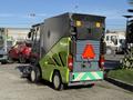 2015 Tennant 636 Green Machine compact street sweeper with a green and gray exterior featuring a triangular warning sign on the back
