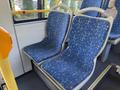 Two empty blue bus seats with a geometric pattern in a 2016 Grande West Vicinity bus interior
