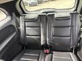 Interior of a 2015 Dodge Durango featuring rear leather seats with headrests and seatbelts