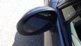 A 2007 Mazda Miata with a sleek design featuring a distinctive side mirror
