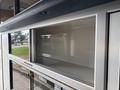 A storage compartment in a 2020 Mercedes-Benz Sprinter 2500 featuring clean lines and a metallic finish with no visible contents inside