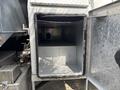 An empty storage compartment of a 2016 RAM 5500 with metal walls and a diamond plate exterior
