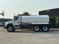 2016 Freightliner M2 106 truck with a large white tank on the back and six wheels visible from the side