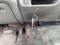 Interior view of a 2004 Ford F-350 SD showing exposed wiring and a missing panel near the dashboard area with pedals visible on the floor