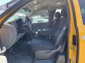 Interior view of a 2013 Chevrolet Silverado 1500 showing the driver's seat with a center console and dark fabric upholstery
