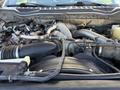 Close-up view of the engine compartment of a 2020 Ford F-550 featuring various automotive components including hoses and tubes