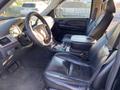 Interior of a 2007 Cadillac Escalade featuring black leather seats a central console and a steering wheel