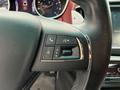 Close-up of a 2016 Maserati Ghibli steering wheel control panel featuring buttons for phone and voice commands