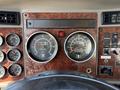 Dashboard of a 2009 Kenworth T270 featuring speedometer and tachometer gauges along with various control buttons and switches