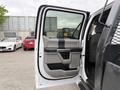 A 2020 Ford F-550 with an open driver's side door displaying the interior door panel design and handle