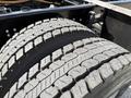 Close-up of a heavily treaded tire on a 2022 Lion Lion6 showing deep grooves and wear indicating use on a vehicle