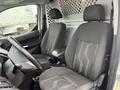 Interior of a 2017 Ford Transit Connect showing two front seats with a simple gray fabric design and a steering wheel in the foreground