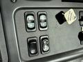 Control panel featuring four buttons for various functions and a key tag labeled PARTING BRAKE