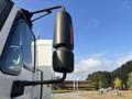 A 2012 International DuraStar 4300 truck featuring a side mirror and a cylindrical exhaust stack