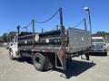 2007 Freightliner M2 106 truck with a black metal bed and a flatbed design featuring a chain link around the edges