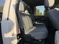Interior view of the rear seating area of a 2014 Ford F-550 with gray fabric seats and a partition behind the front seats
