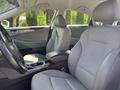 Interior of a 2014 Hyundai Sonata featuring gray seats and a center console with various controls and storage compartments