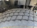 Close-up of a large, worn tire with distinct tread pattern of a 2013 International 7500 showing signs of use and surface texture