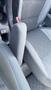 Close-up of the armrest and seat interior of a 2019 Nissan Kicks showcasing black fabric with a diamond pattern