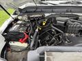 The image shows the engine compartment of a 2015 Ford F-350 SD featuring the engine, battery, and various hoses and components