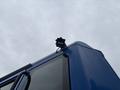 A blue 2017 Autocar Xpert truck with a light mounted on the roof angled towards the sky