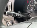 A close-up of the turn signal and wiper control stalk in a 2018 Chevrolet Express featuring various indicator settings and a sleek black design
