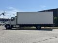 A 2020 Hino 338 box truck with a blank white cargo area and a flatbed rear is parked on a paved surface