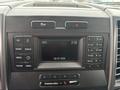 A 2017 Ford F-150 dashboard showing the radio and display controls with a digital clock and date