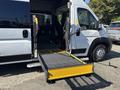 A 2020 RAM ProMaster 3500 with a yellow wheelchair ramp extended from the rear door