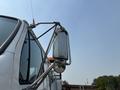 A close-up of the side mirror of a 2006 Sterling Acterra truck showing the reflective surface and the supporting metal frame