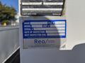 A blue and white inspection sticker displaying vehicle information for a 2013 International 7500 including make model serial number and inspection details