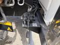 A hydraulic control valve mounted on a bracket with labels indicating function and operation for a 2011 International 4300 truck
