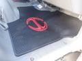 A rubber floor mat featuring a red logo in the shape of a stylized letter C inside another C in a vehicle interior