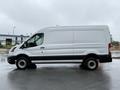 A white 2022 Ford Transit van shown from the side with a long cargo area and black trim on the lower portion of the vehicle