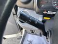 A close-up of the control stalk in a 2018 Hino 195 featuring switches for headlights turn signals and wipers