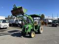 A 2008 John Deere 3320 300X tractor with a front loader attachment in bright green and yellow colors parked on a lot