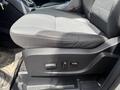 A black cloth car seat from a 2015 Ford Escape showing controls for seat adjustments on the side