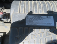 A 2020 Chevrolet Express engine with a visible vehicle emission control information label mounted on the engine cover