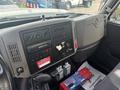 Dashboard of a 2012 International 7300 Workstar featuring various control panels gauges and a radio with additional equipment on the floor