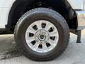 Close-up of a 2021 Ford F-350 SD wheel featuring a silver alloy rim and a Sumitomo tire with a rugged tread pattern