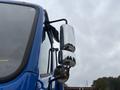 A blue 2017 Autocar Xpert truck with chrome side mirrors and a visible cabin window