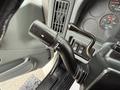 Close-up of a 2006 International 4300 truck's control lever showing wiper and turn signal functions along with part of the dashboard and gauges visible